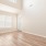 a room with a wood floor and a window