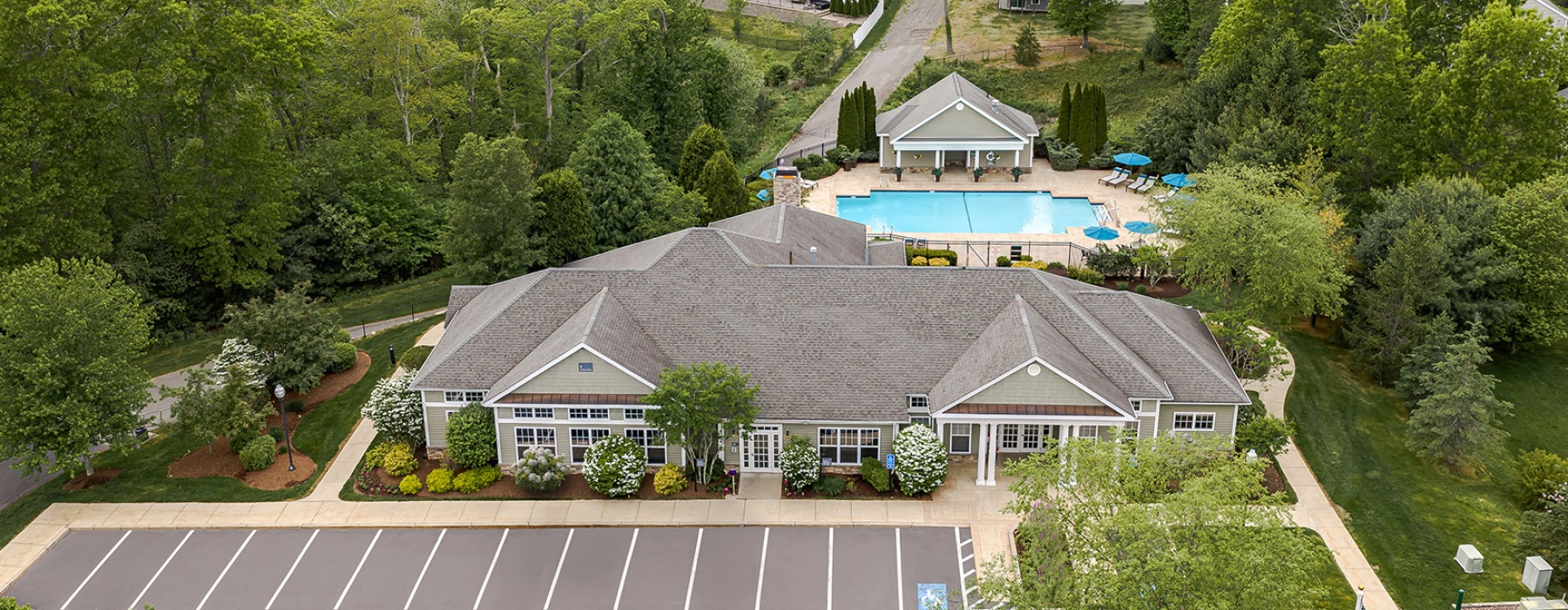 a building with a parking lot and a pool in the back