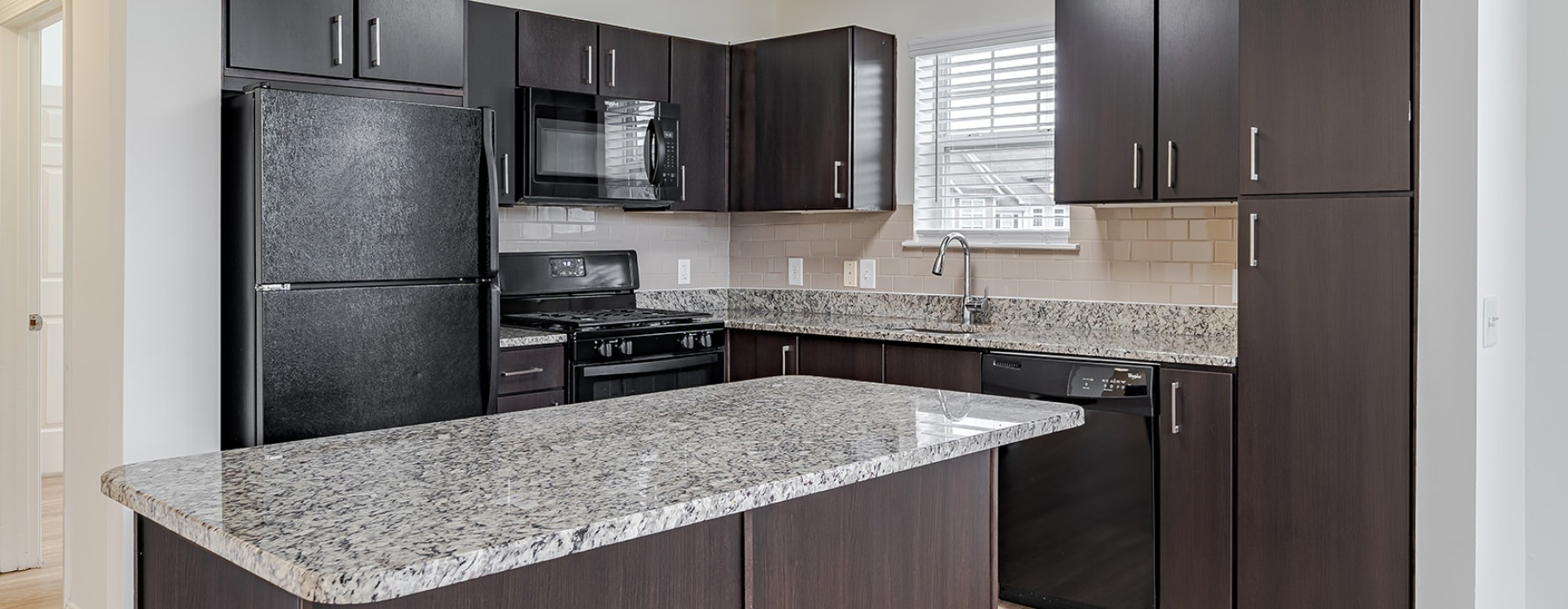 kitchen with brown cabinets and black appliances
