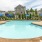 a pool with umbrellas and chairs by it